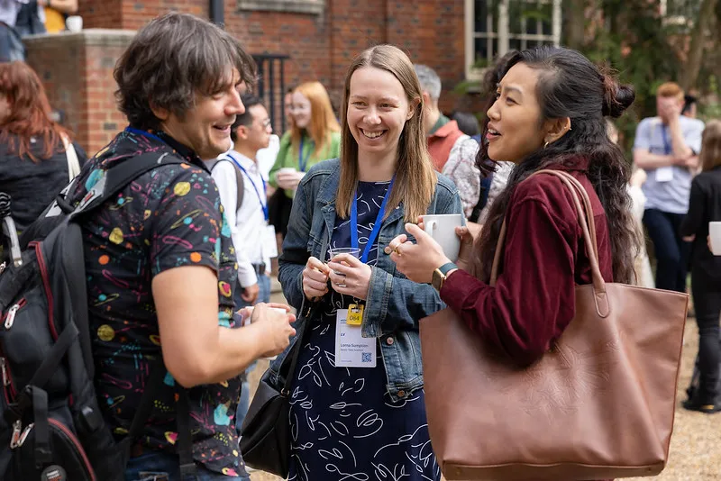 Group of people having a blast outdoors at the conference..